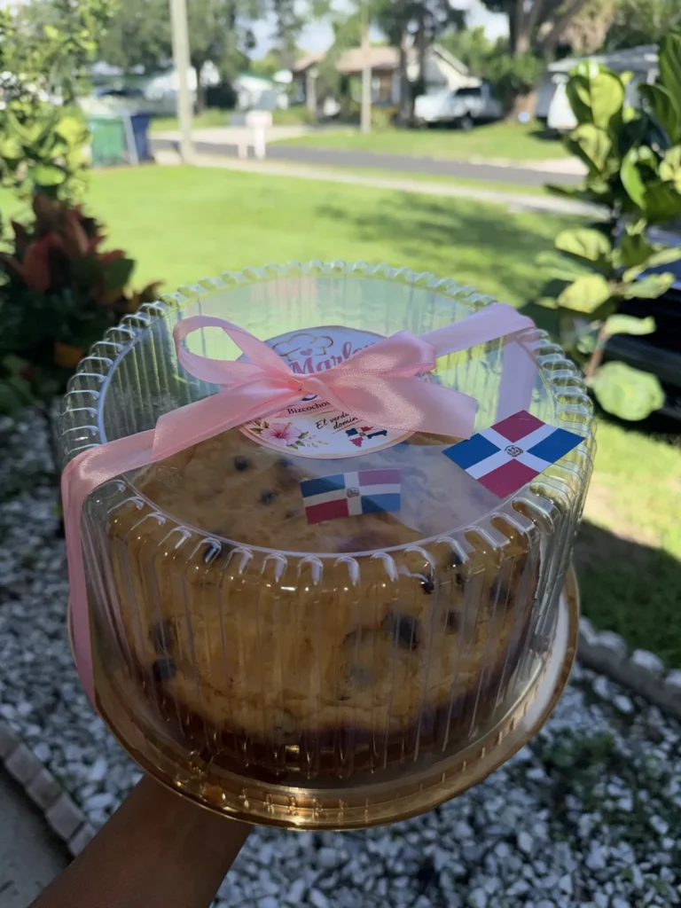 Packaged cake ready for pickup tied with a pink ribbon