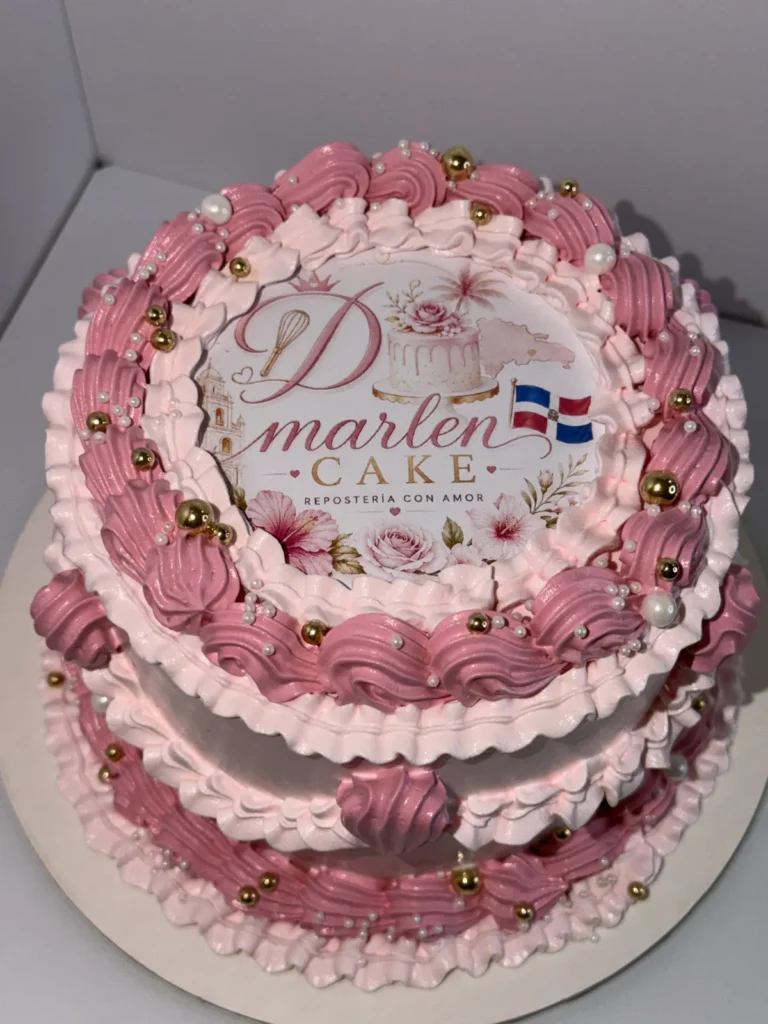 Pink buttercream cake topped with the D'Marlen Cake logo