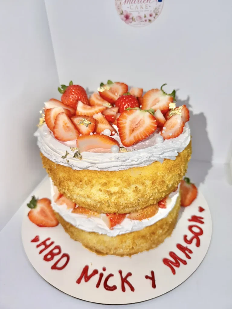 Naked layer cake topped with fresh strawberries